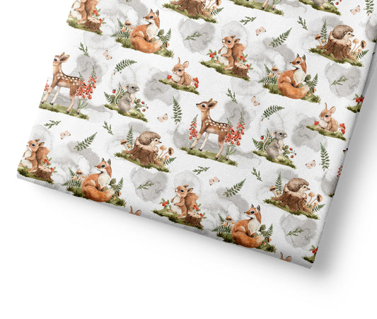 Woodland animal patterned fabric with deer, rabbits, and hedgehogs on a white background