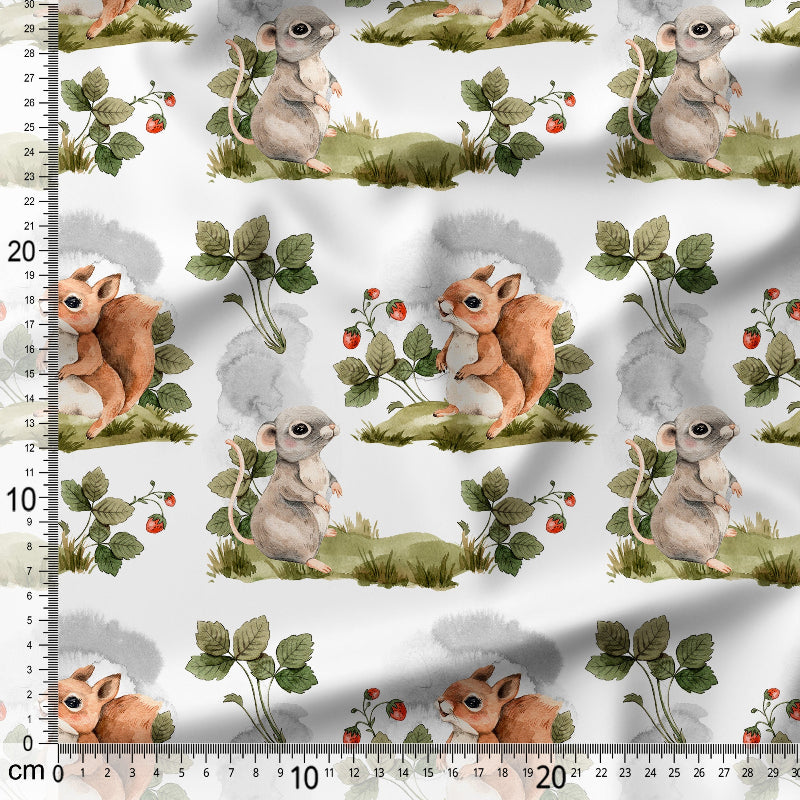 Fabric with animal pattern featuring small creatures and plants on a white background, with a ruler for scale.
