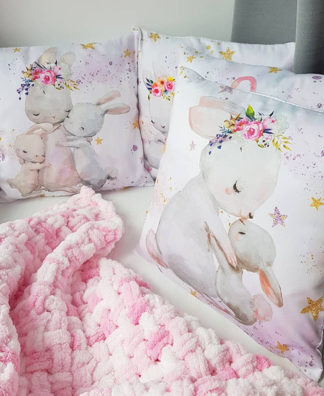 Three pillows with a print of cute bunny family