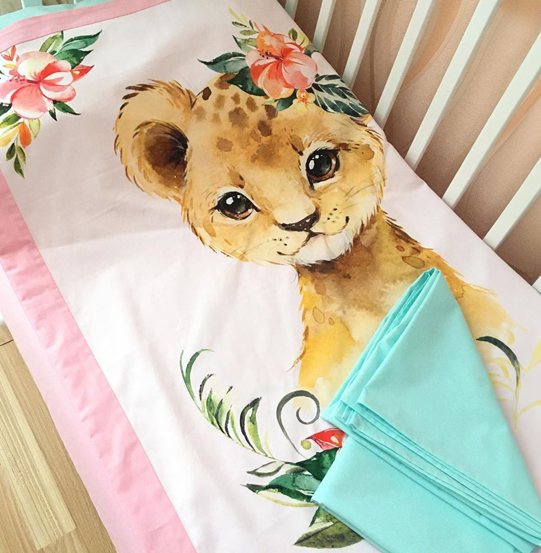Cotton fabric with a print of cute baby lion with the bright flowers on the head