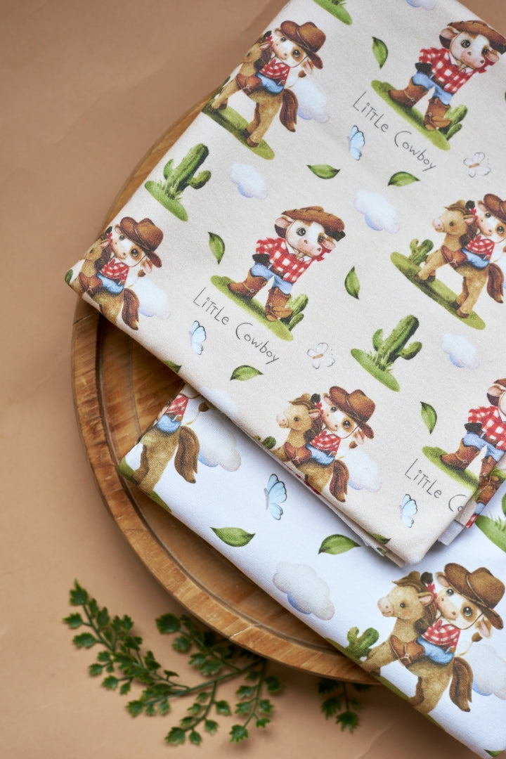 Cotton fabric with a print of cute cowboy on a horse