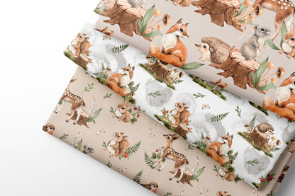 Woodland animal-themed coordinating fabric with deer, fox, and rabbit designs on a white background.