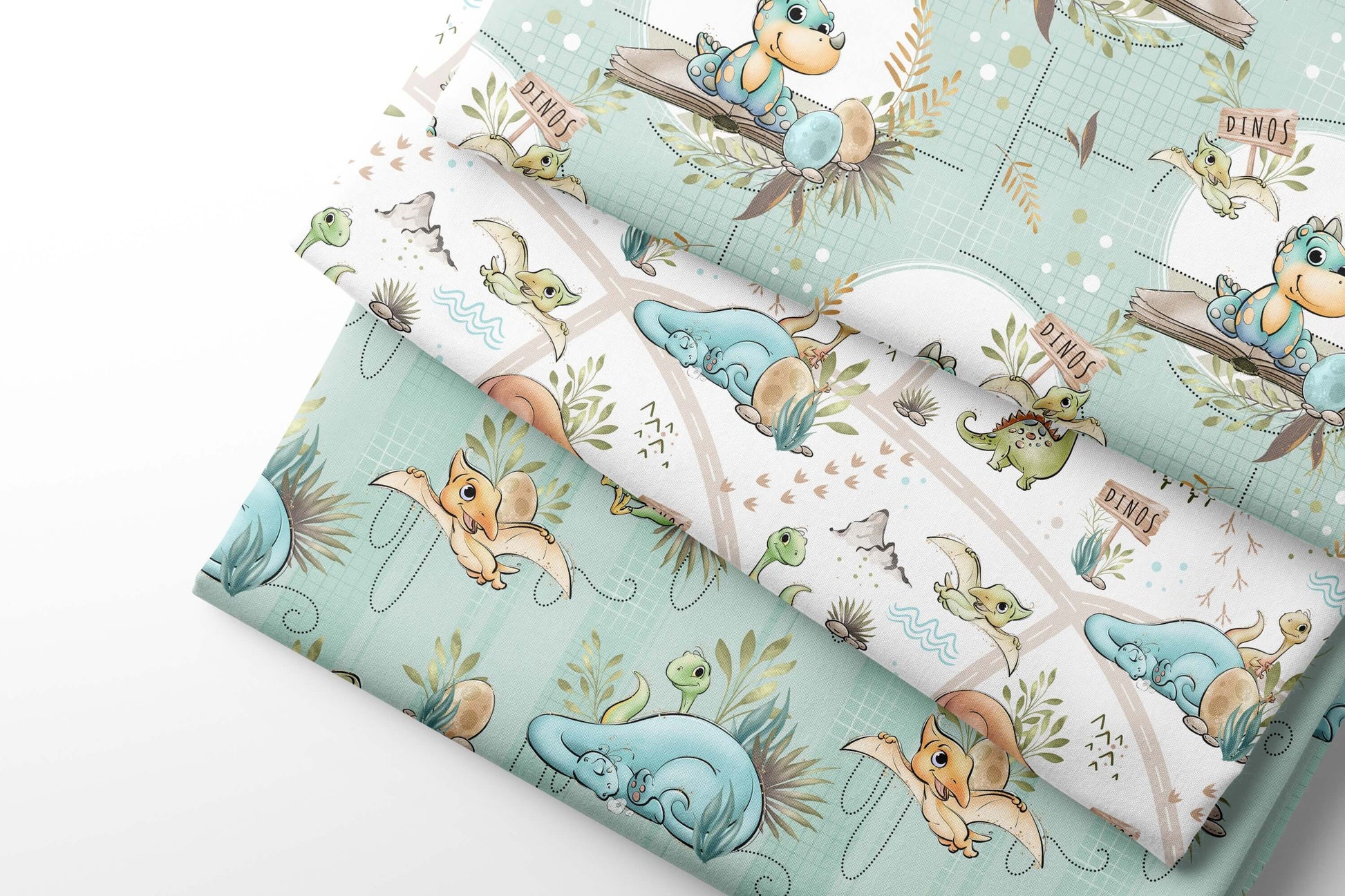 Set of fabric swatches with cartoon dino designs on a light blue, green background