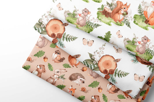 Woodland-themed fabric with animals and nature elements on a white background