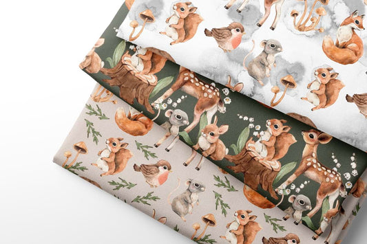 Three sheets of coordintaing fabric with animal patterns on a white background