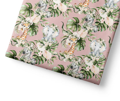 Patterned coordinating fabric with animals and leaves on a pink background