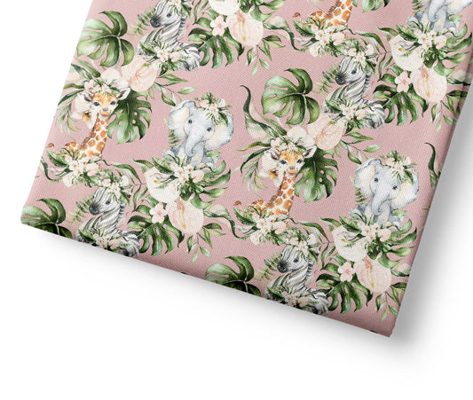 Patterned coordinating fabric with animals and leaves on a pink background
