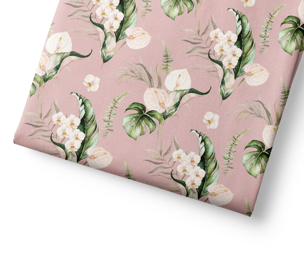 Floral patterned fabric with white flowers and green leaves on a pink background