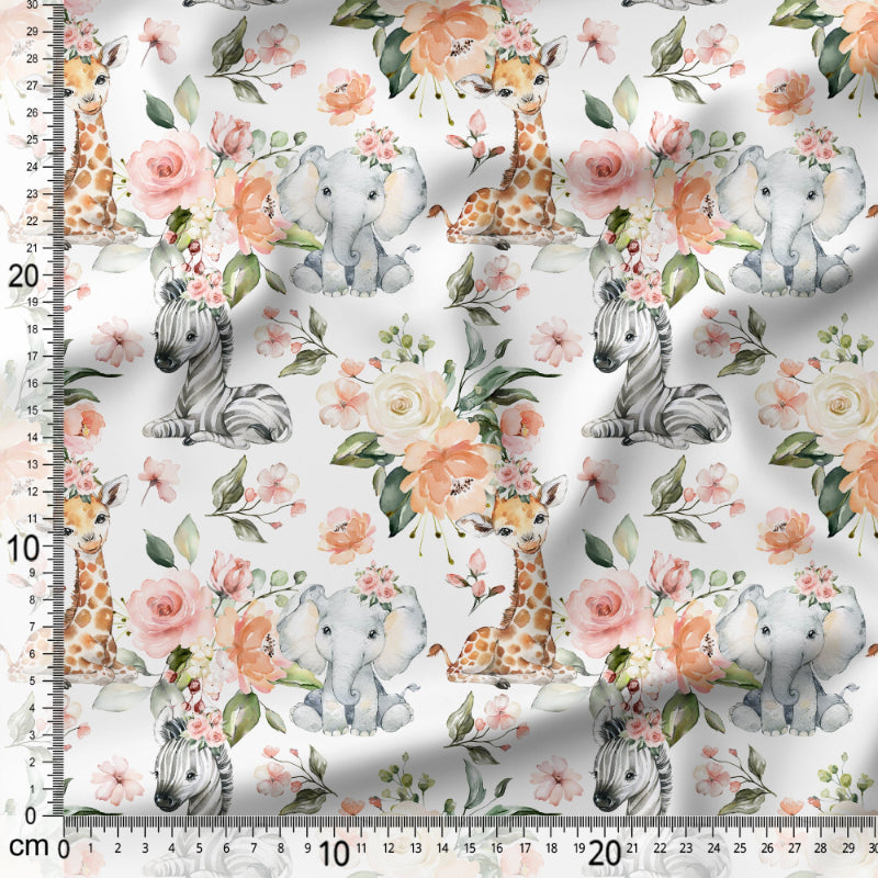 Fabric with baby animals and flowers pattern on a white background with a ruler for scale.