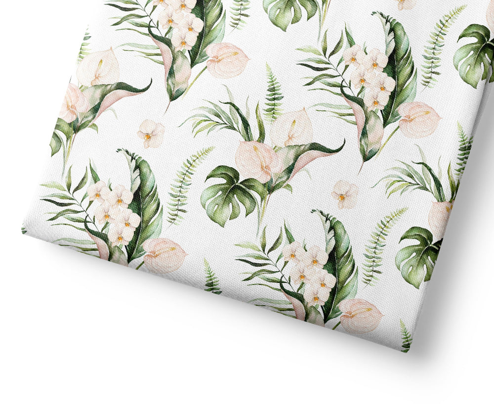 Tropical floral patterned fabric with green leaves and white flowers on a white background