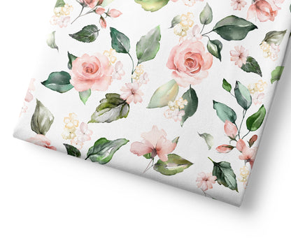 Floral patterned paper with pink roses and green leaves on a white background