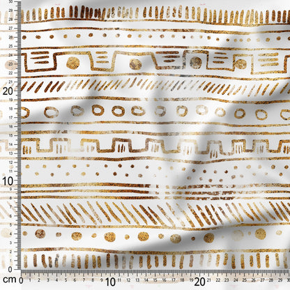 Gold geometric pattern on white fabric with a ruler for scale