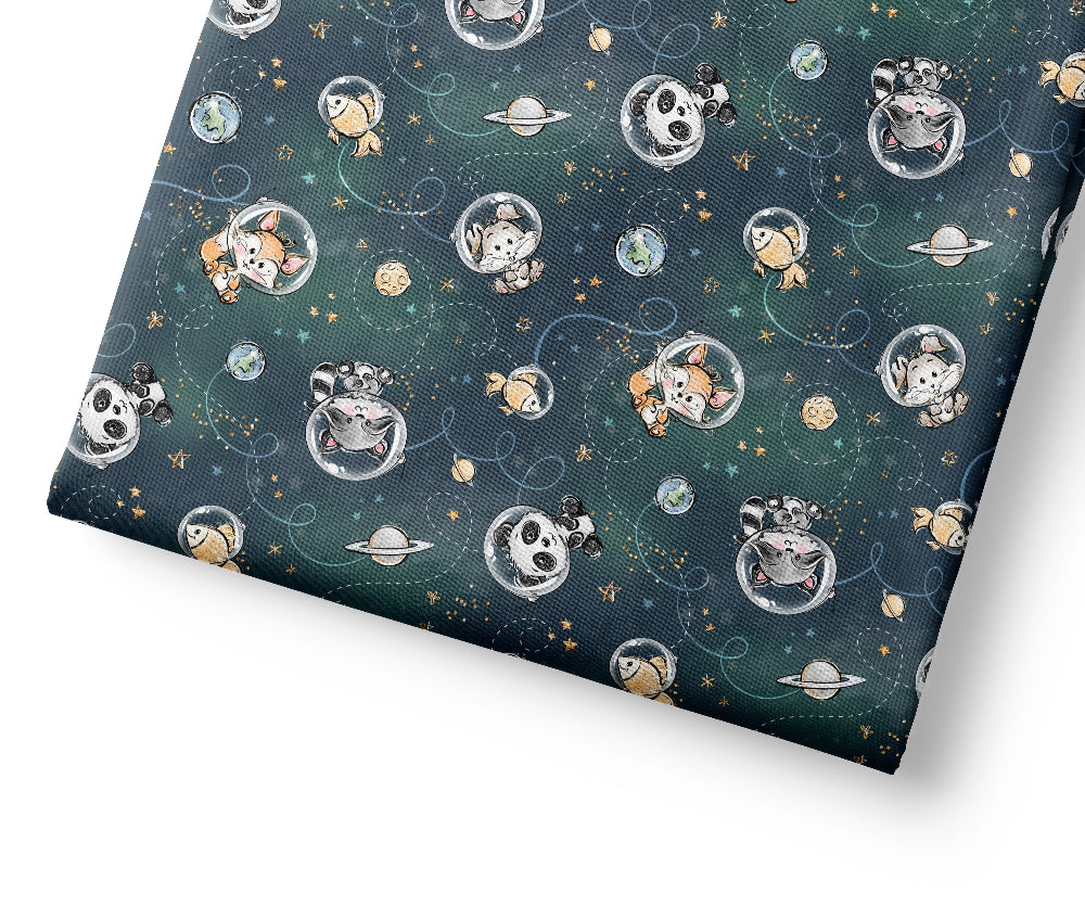 Coordinating fabric with space-themed design featuring planets, stars, and cartoon characters on a dark blue background.