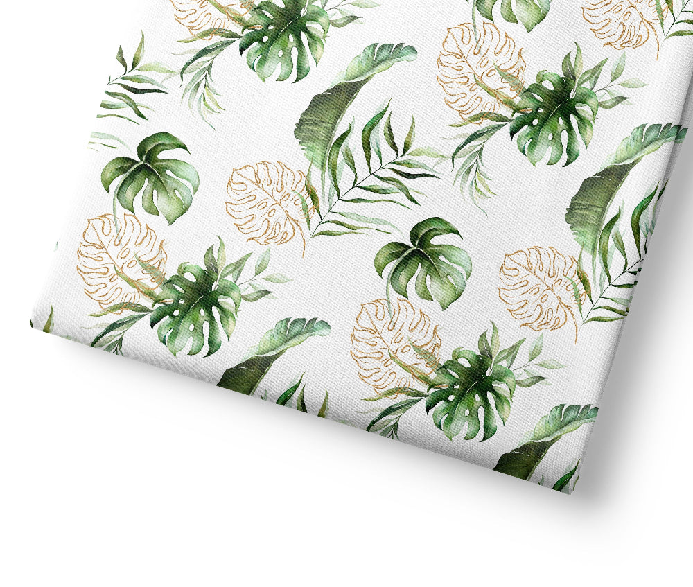Tropical safari leaf patterned fabric with green and gold leaves on a white background