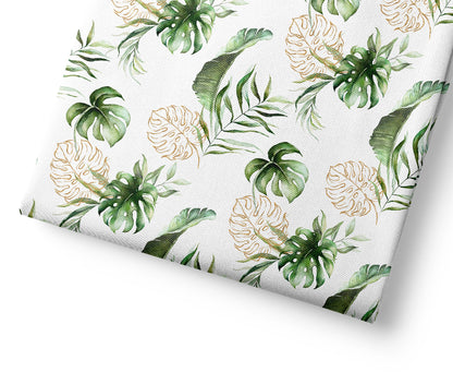Tropical safari leaf patterned fabric with green and gold leaves on a white background