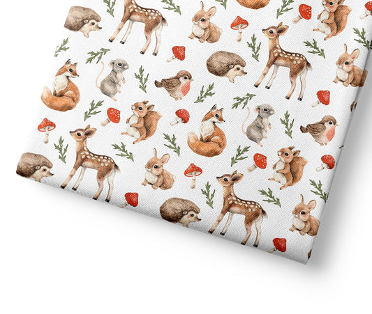 Woodland patterned fabric with a pattern of forest animals on a white background