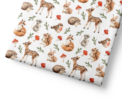 Woodland patterned fabric with a pattern of forest animals on a white background