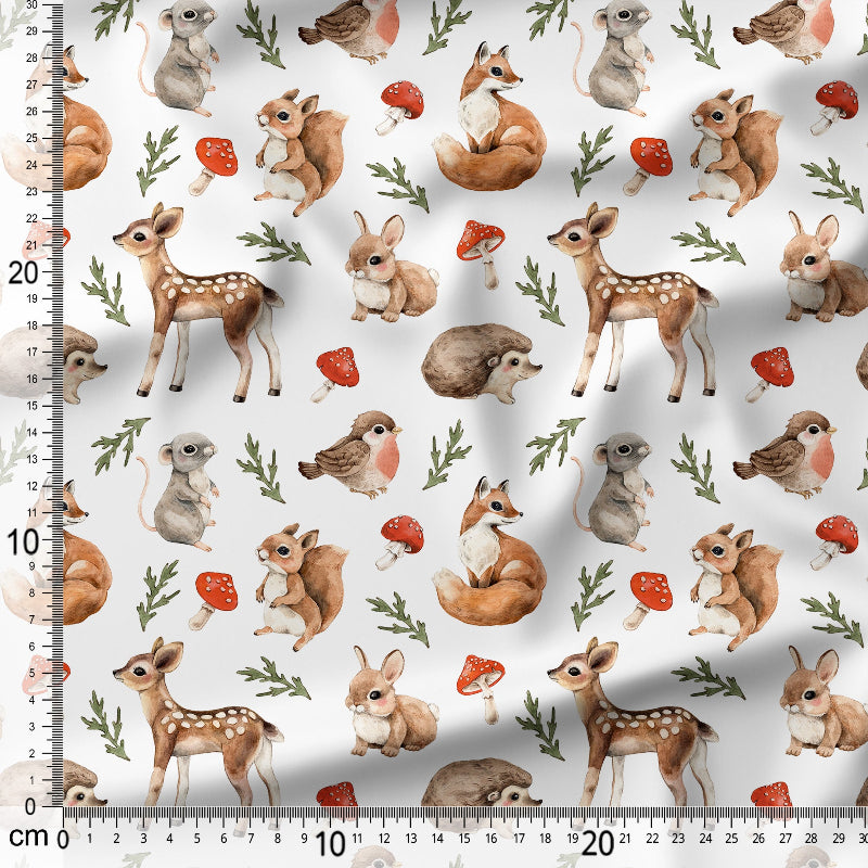 Pattern of forest animals including deer, fox, and birds on a white background with a ruler for scale.