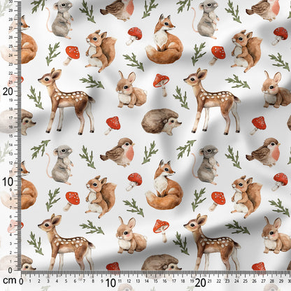 Pattern of forest animals including deer, fox, and birds on a white background with a ruler for scale.