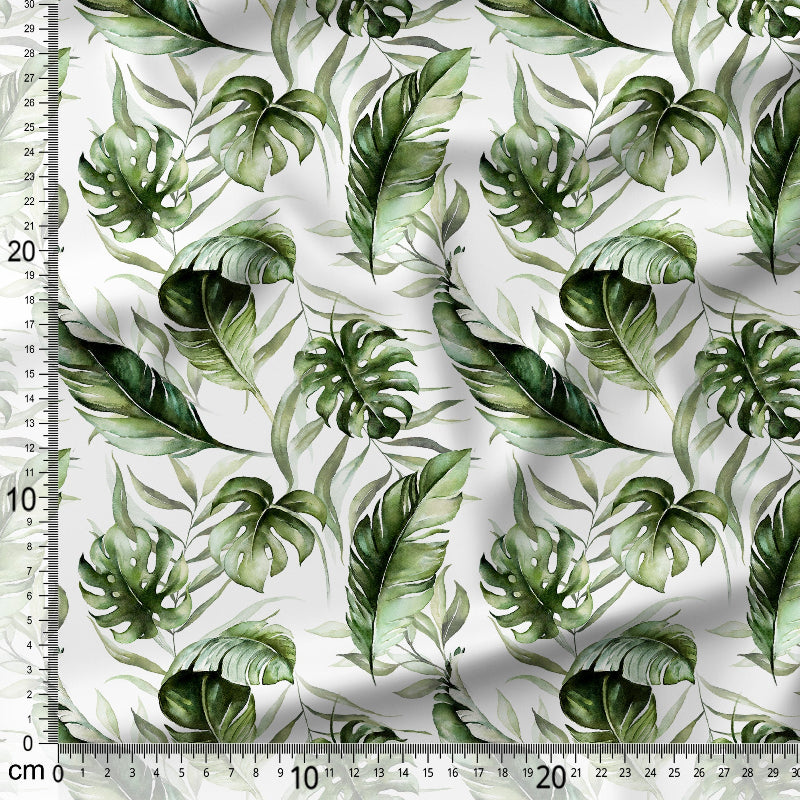 Green leaf pattern fabric with a ruler for scale on a white background