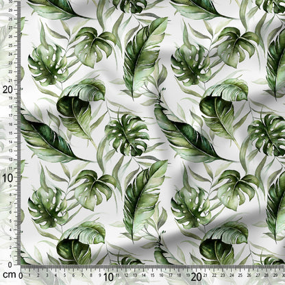 Green leaf pattern fabric with a ruler for scale on a white background