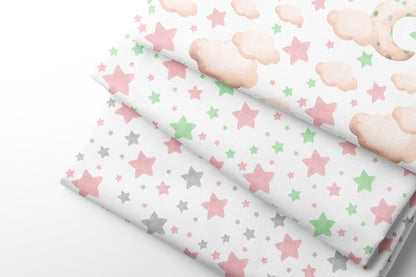 Three rolls of fabric with stars and clouds patterns on a white background