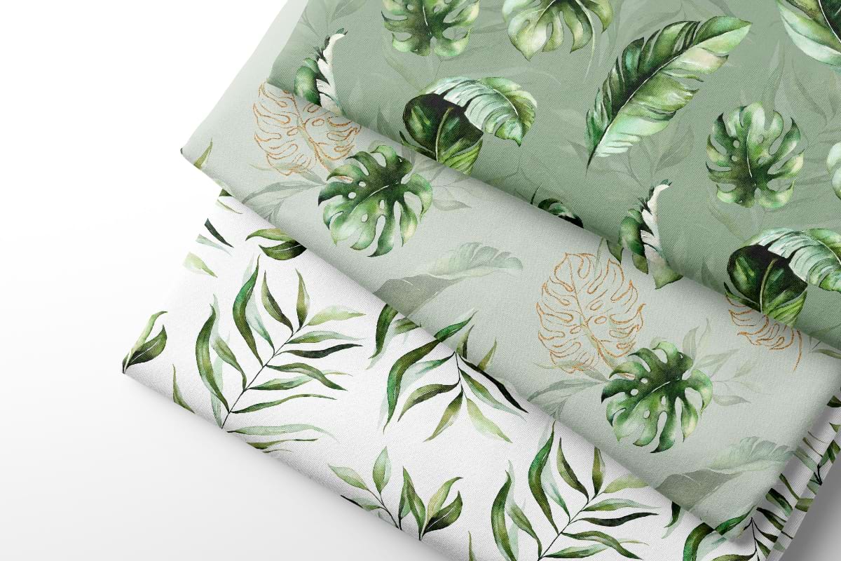 Three sheets of coordinating fabric with green leaf patterns on a white background
