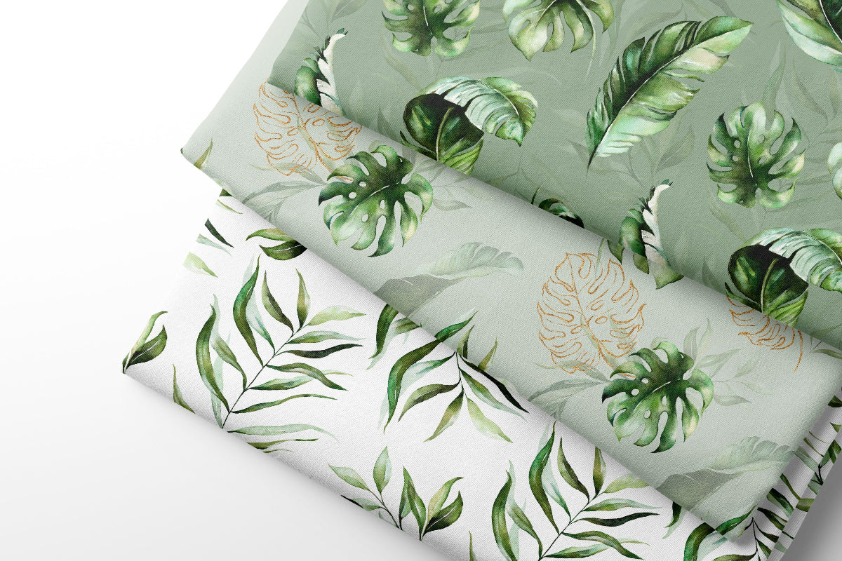 Three sheets of coordinating fabric with green leaf patterns on a white background
