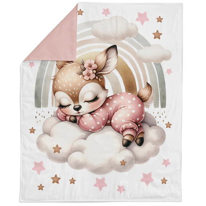 Blanket with a cartoon deer character on a cloud, surrounded by stars and a rainbow.