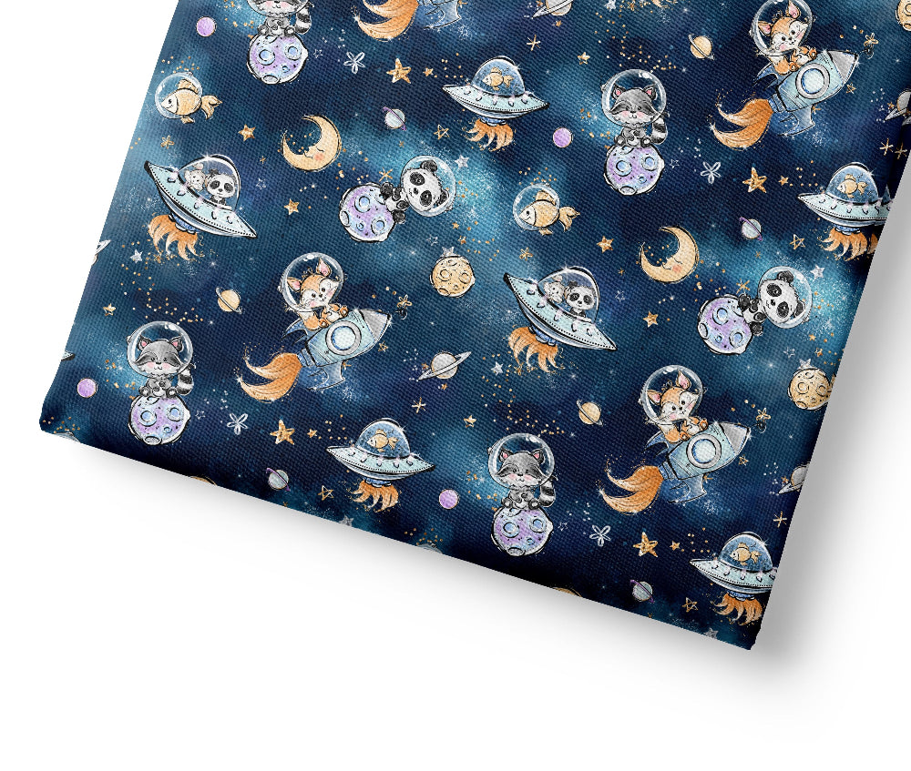 Patterned fabric with space-themed design featuring astronauts, planets, and rockets on a blue background.