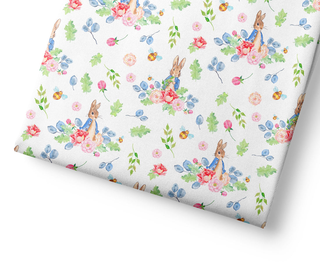 Floral patterned coordinating fabric with peter rabbit on a white background