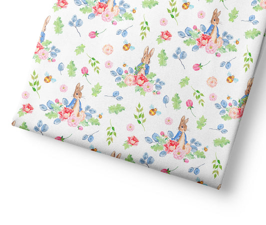Floral patterned coordinating fabric with peter rabbit on a white background