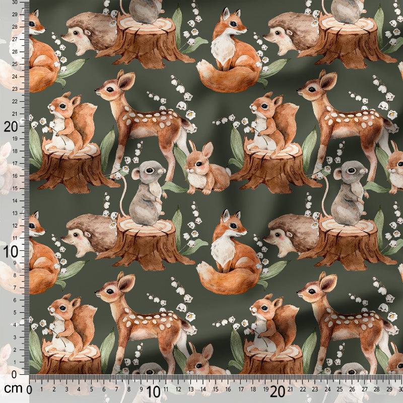 Patterned fabric of forest animals with a ruler for scale.
