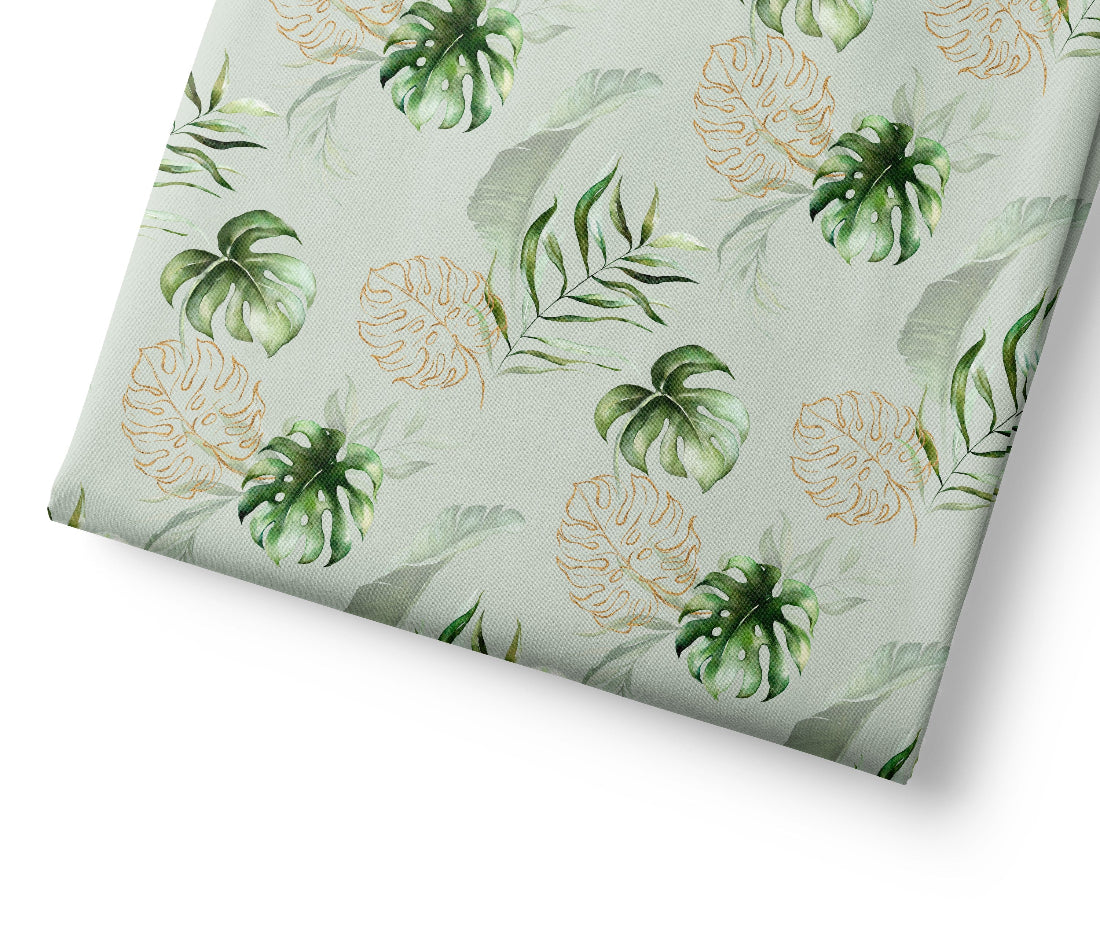 Tropical leaf patterned fabric on a light green background