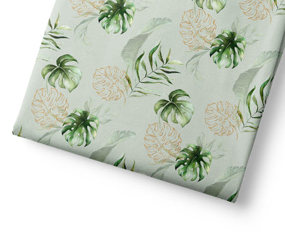Tropical leaf patterned fabric on a light green background