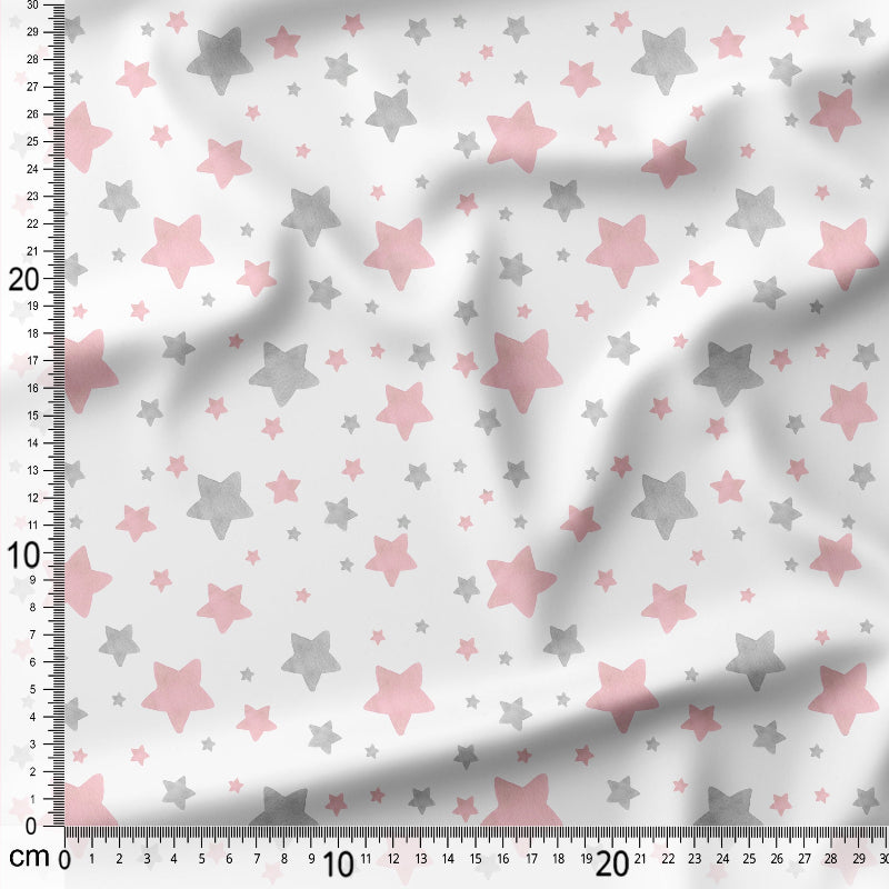 Fabric with pink and gray star pattern on a white background, measured with a ruler.