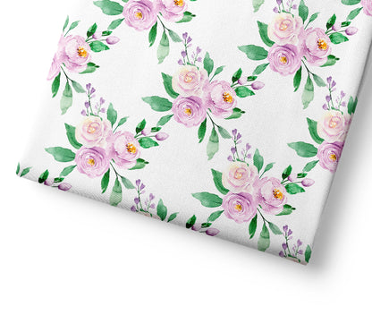 Floral patterned fabric with pink and green flowers on a white background