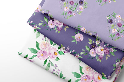 Three fabric sheets of floral-patterned paper in purple, white, and a mix of both.