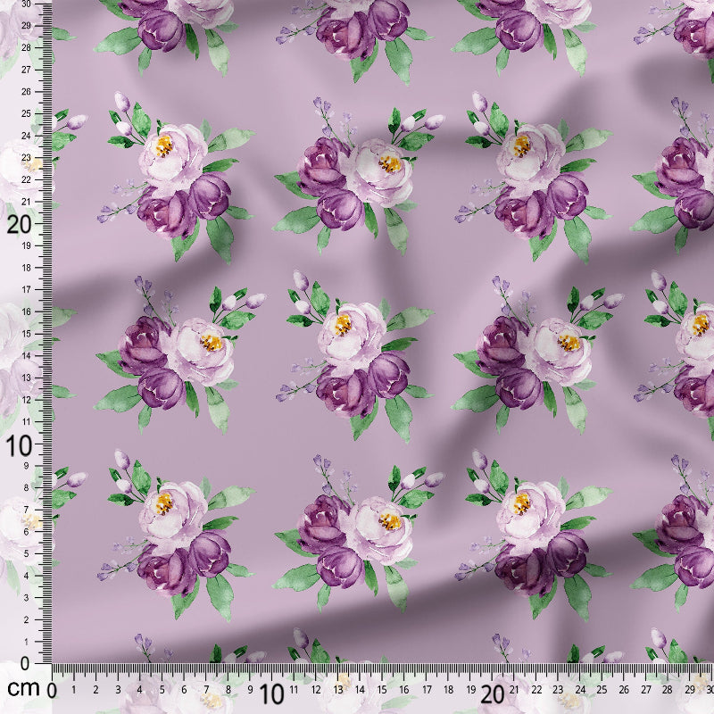 Floral patterned fabric with purple and green flowers on a light purple background, measured with a ruler.