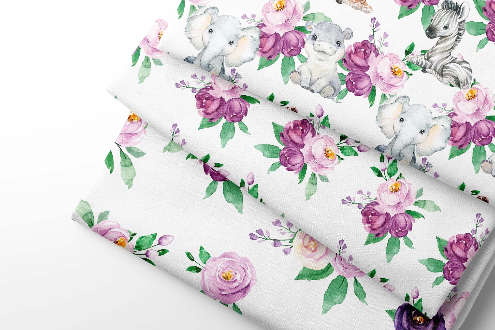 Three sheets of floral-patterned fabric with safari animals and flowers on a white background.