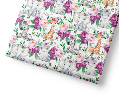 Floral patterned fabric with safari baby animals and flowers on a white background