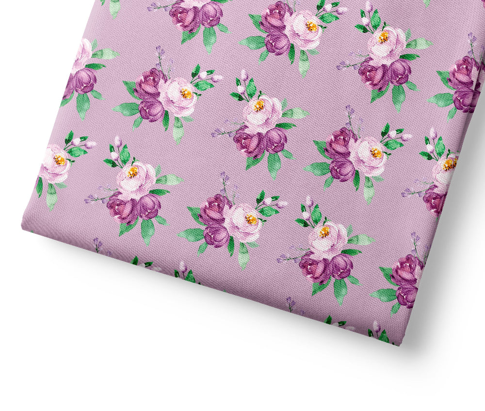 Floral patterned fabric with purple and pink flowers on a light purple background
