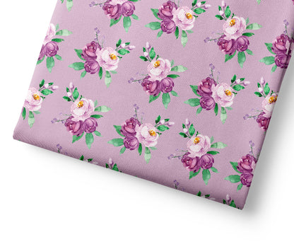Floral patterned fabric with purple and pink flowers on a light purple background