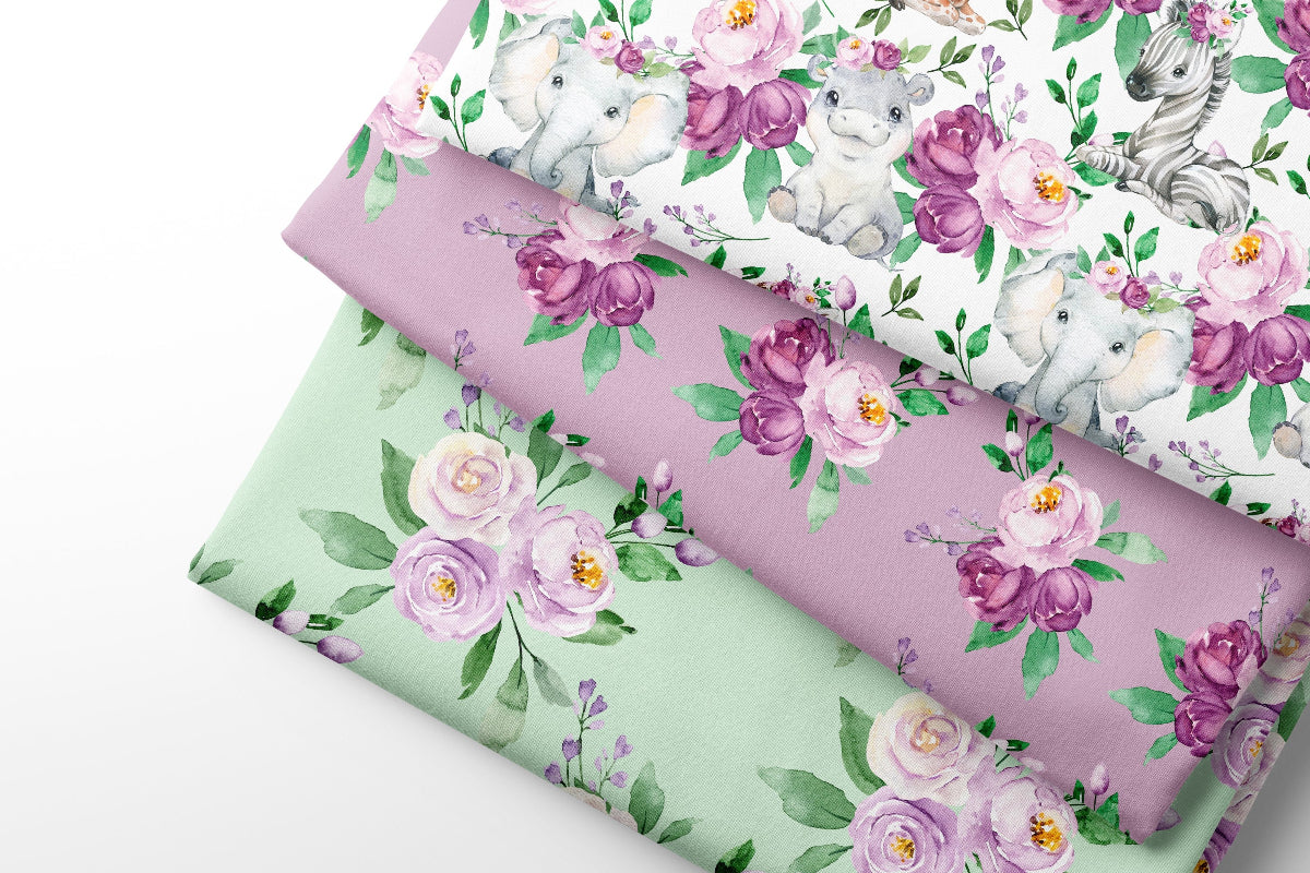 Three rolls of floral-patterned fabric with unicorns and flowers on a white background.