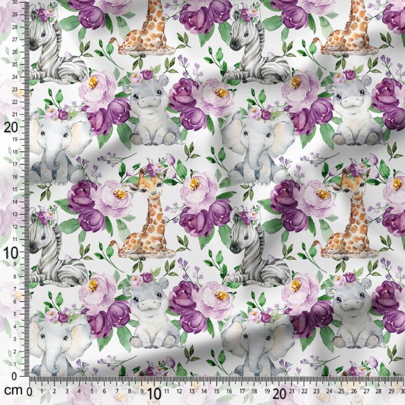 Patterned fabric with baby animals and flowers on a white background, featuring a ruler for scale.