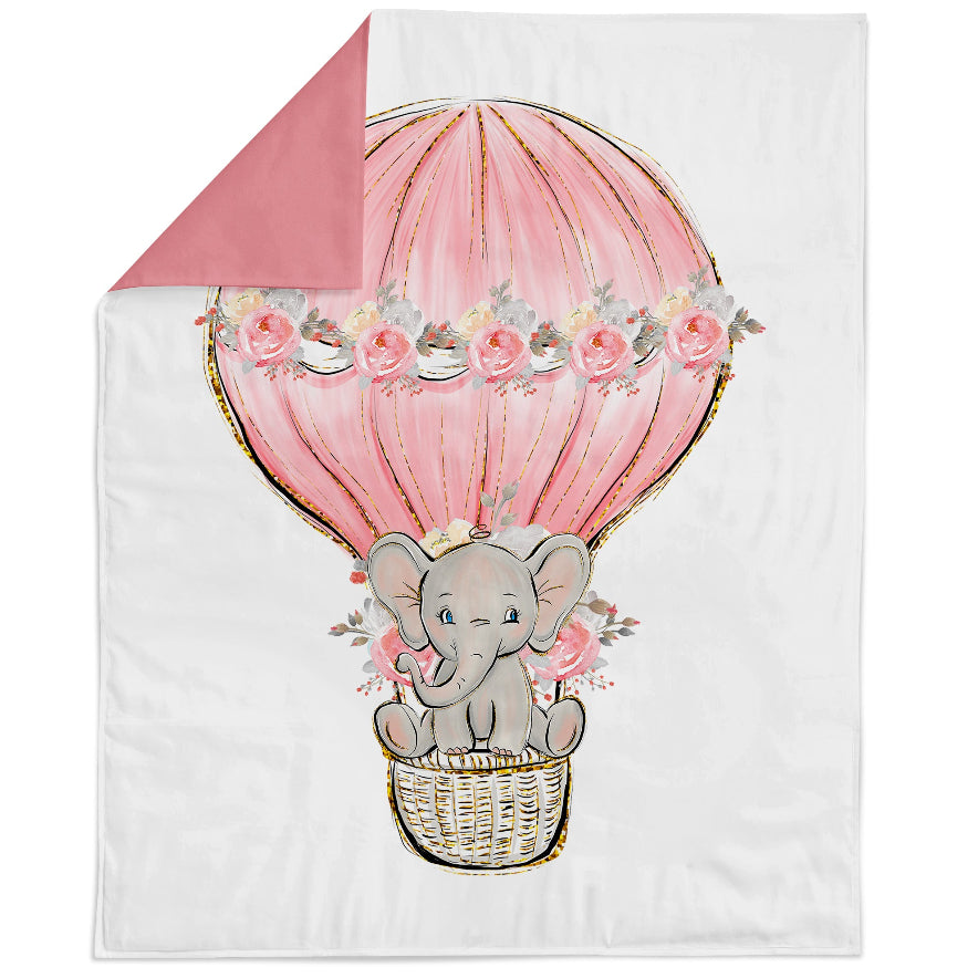 Blanket with an elephant in a pink hot air balloon and floral decorations on a white background