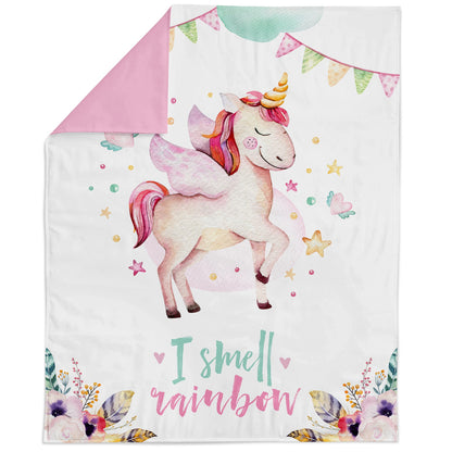 Fabric blanket with a printed unicorn and rainbow design, intended for quilting and crafts.
