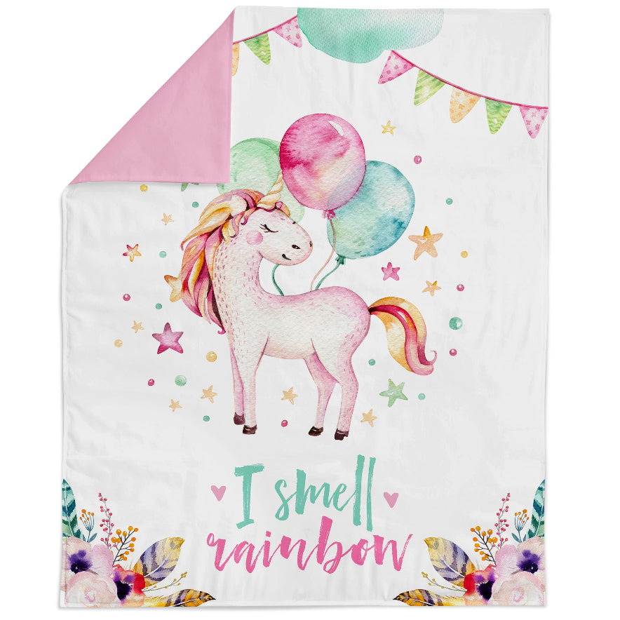 Fabric panel with a unicorn and balloon design, surrounded by colorful stars and flowers, with the text 'I smell a rainbow' at the bottom.