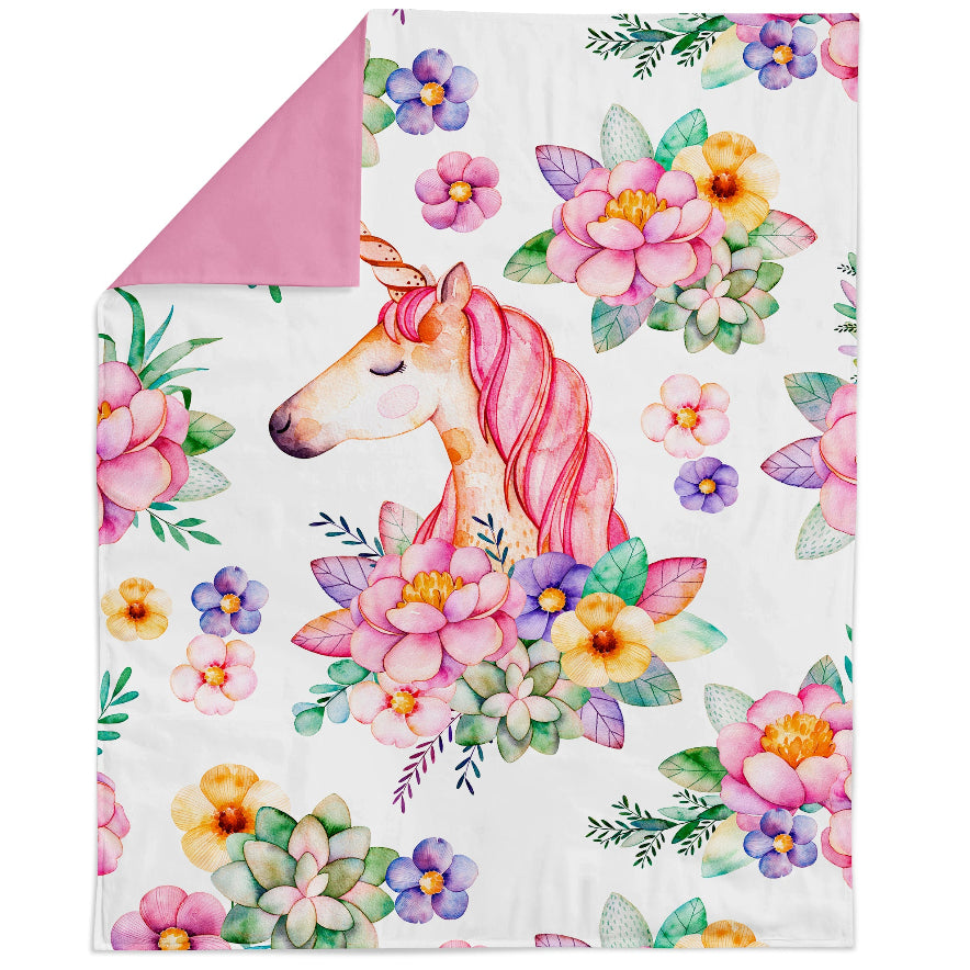 A fabric panel with a bright pink unicorn and flowers, intended for quilting and sewing