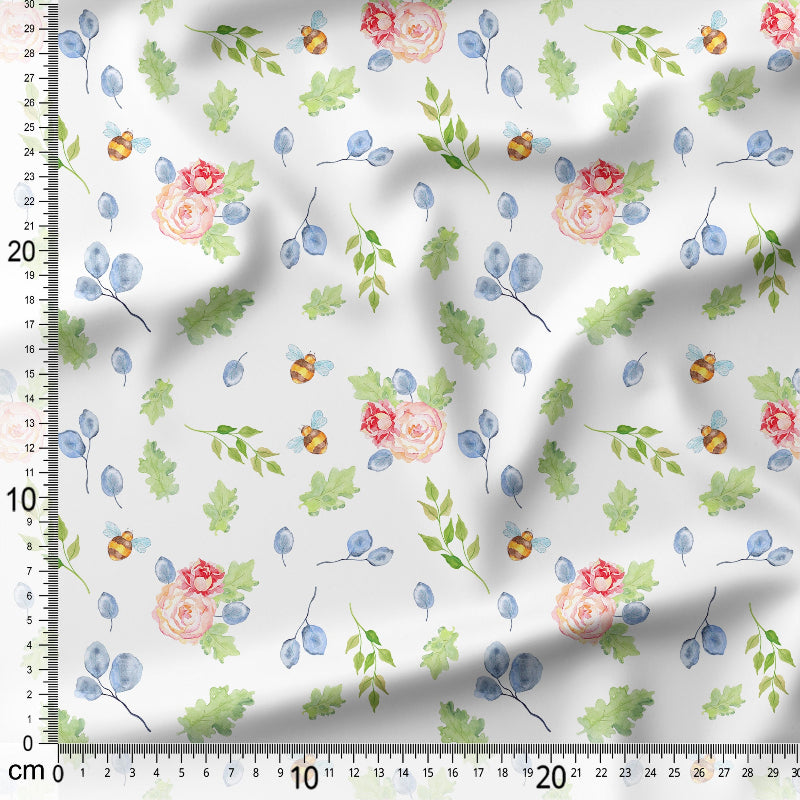 Floral and leaf patterned fabric with a ruler for scale on a white background